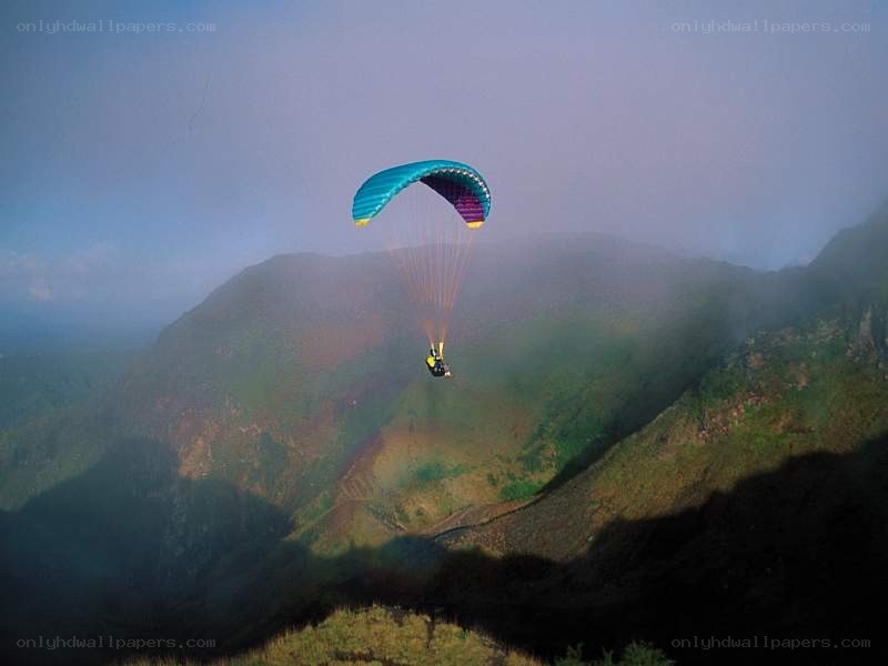 Paraglider over mountain valley