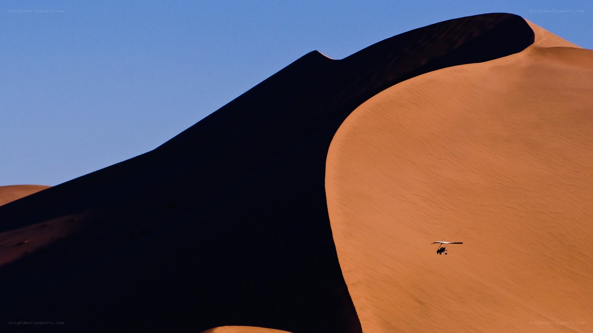 Paraglider over sand dunes