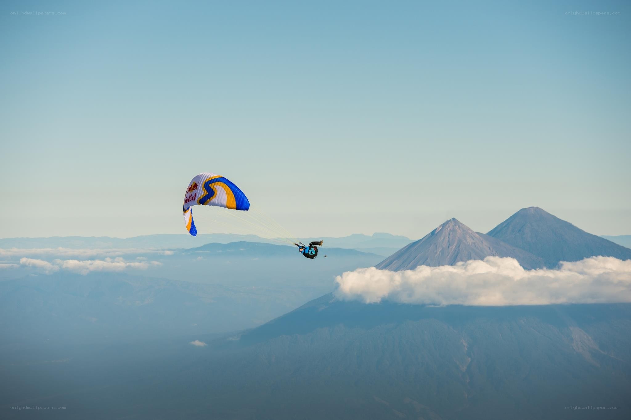 Paraglider over volcanic mountains