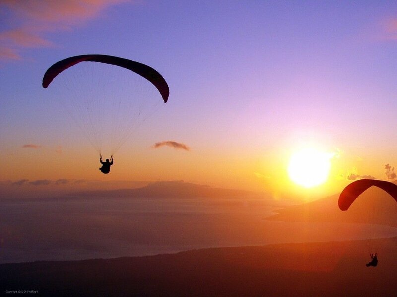 Paragliders at sunset