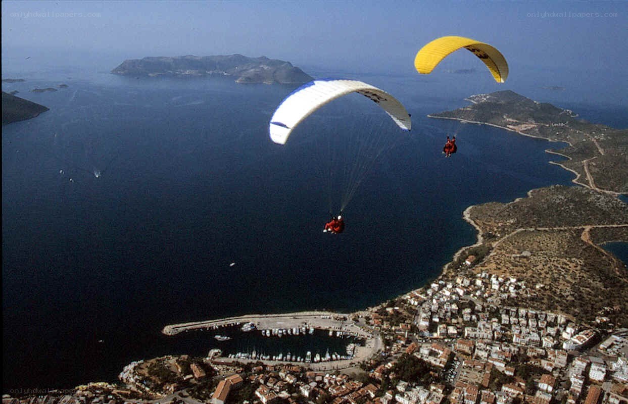Paragliders over coastal town