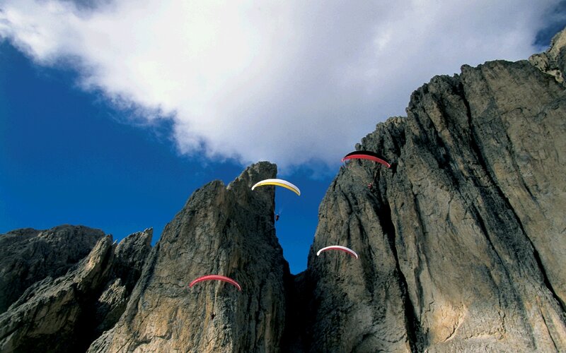 Paragliders over rocky cliffs