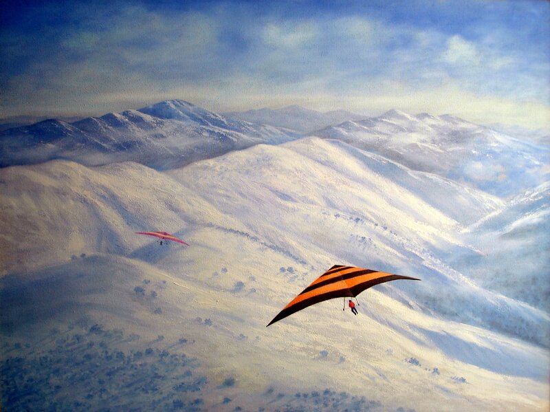 Paragliders over snowy mountains