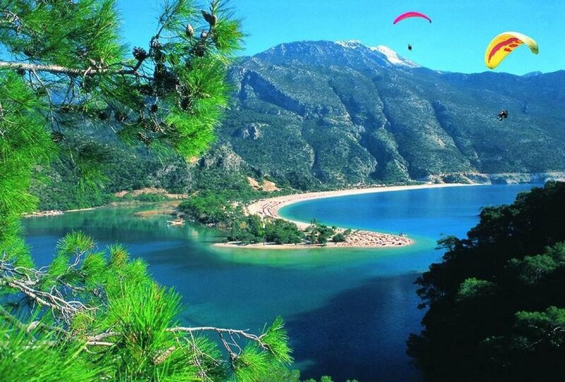 Paragliding over a coastal bay