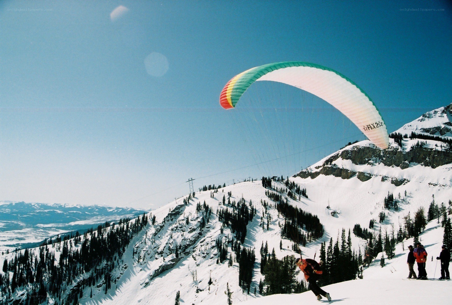 Paragliding over snowy mountains