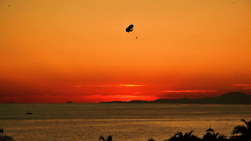 Parasailing over Ocean — Orange