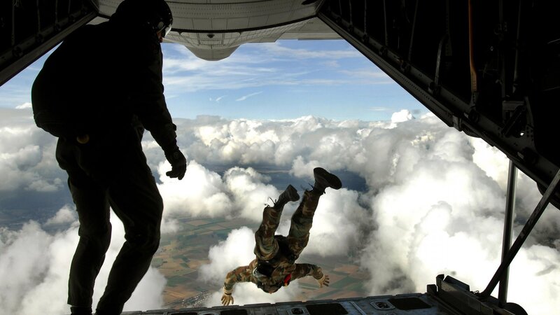 Paratrooper jumping from aircraft
