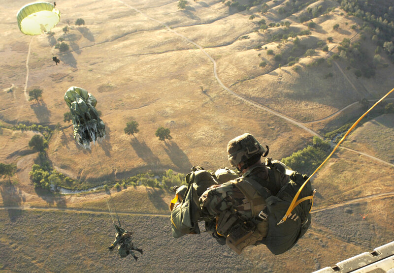 Paratroopers descending by parachute