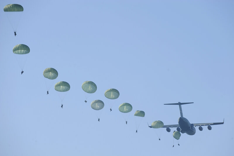 Paratroopers descending from aircraft