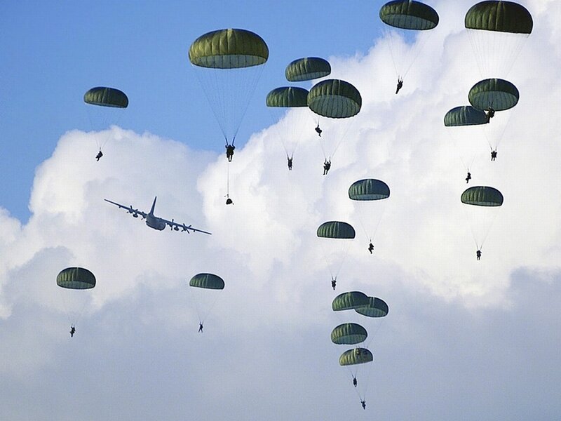 Paratroopers descending from aircraft