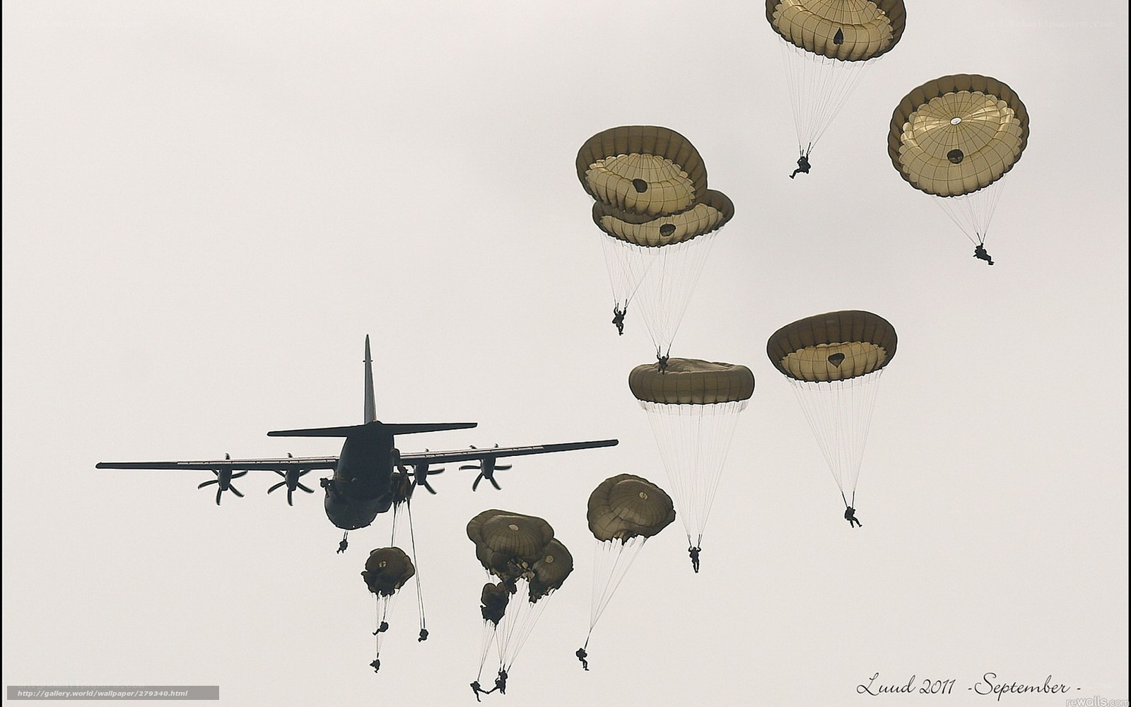 Paratroopers descending from aircraft