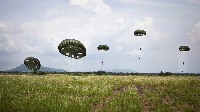 Paratroopers descending on field