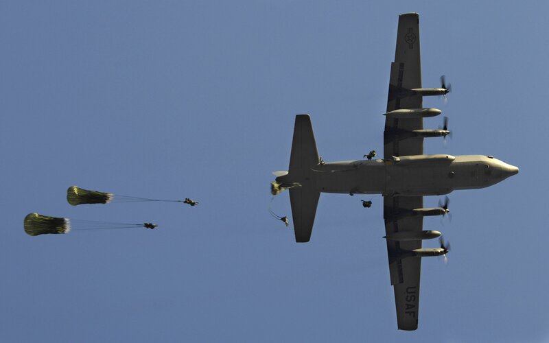 Paratroopers dropping from aircraft