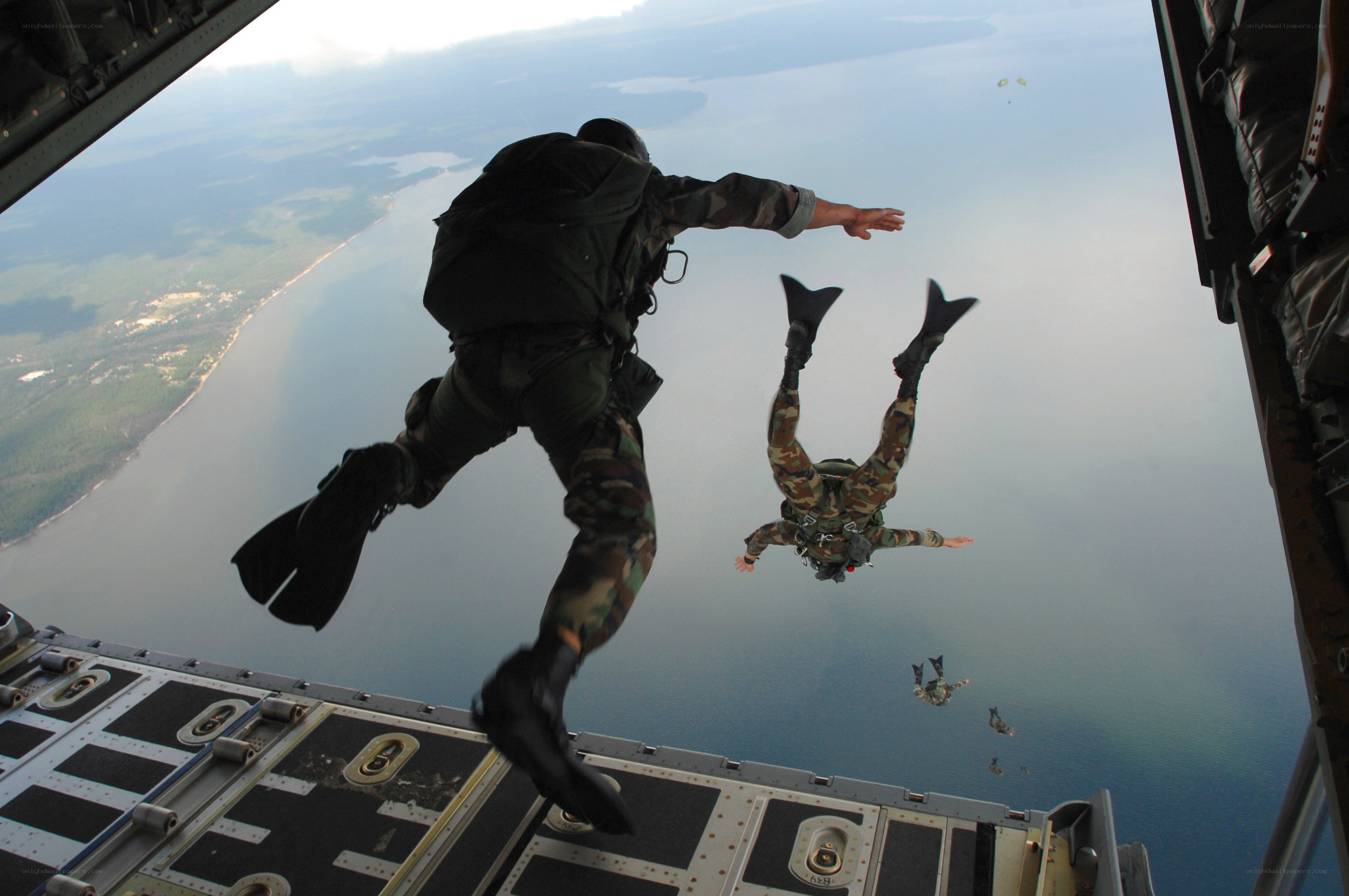 Paratroopers jumping from aircraft