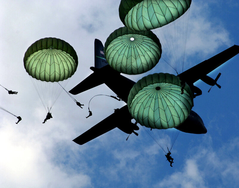 Paratroopers jumping from aircraft