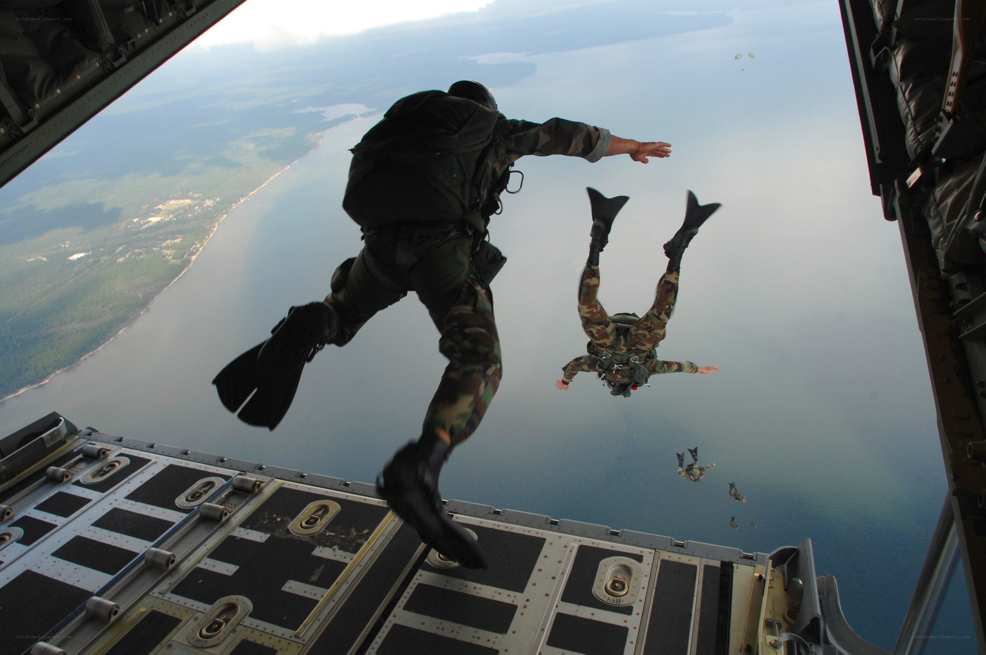Paratroopers jumping from aircraft