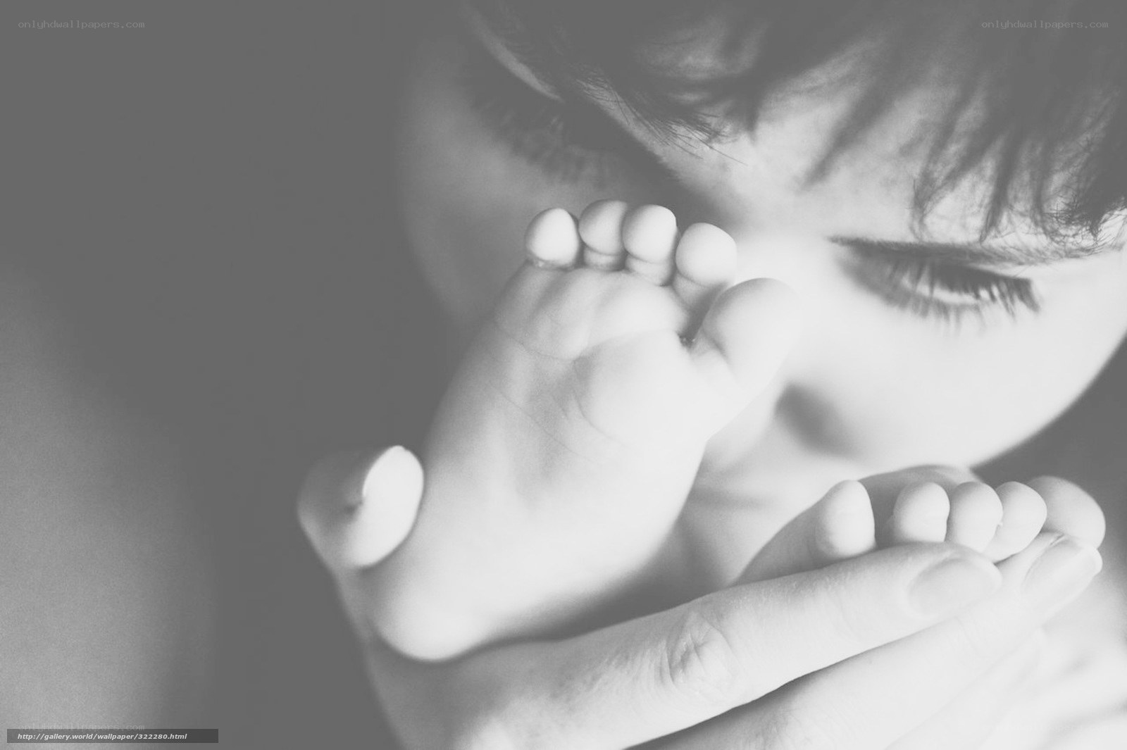 parent holding baby feet