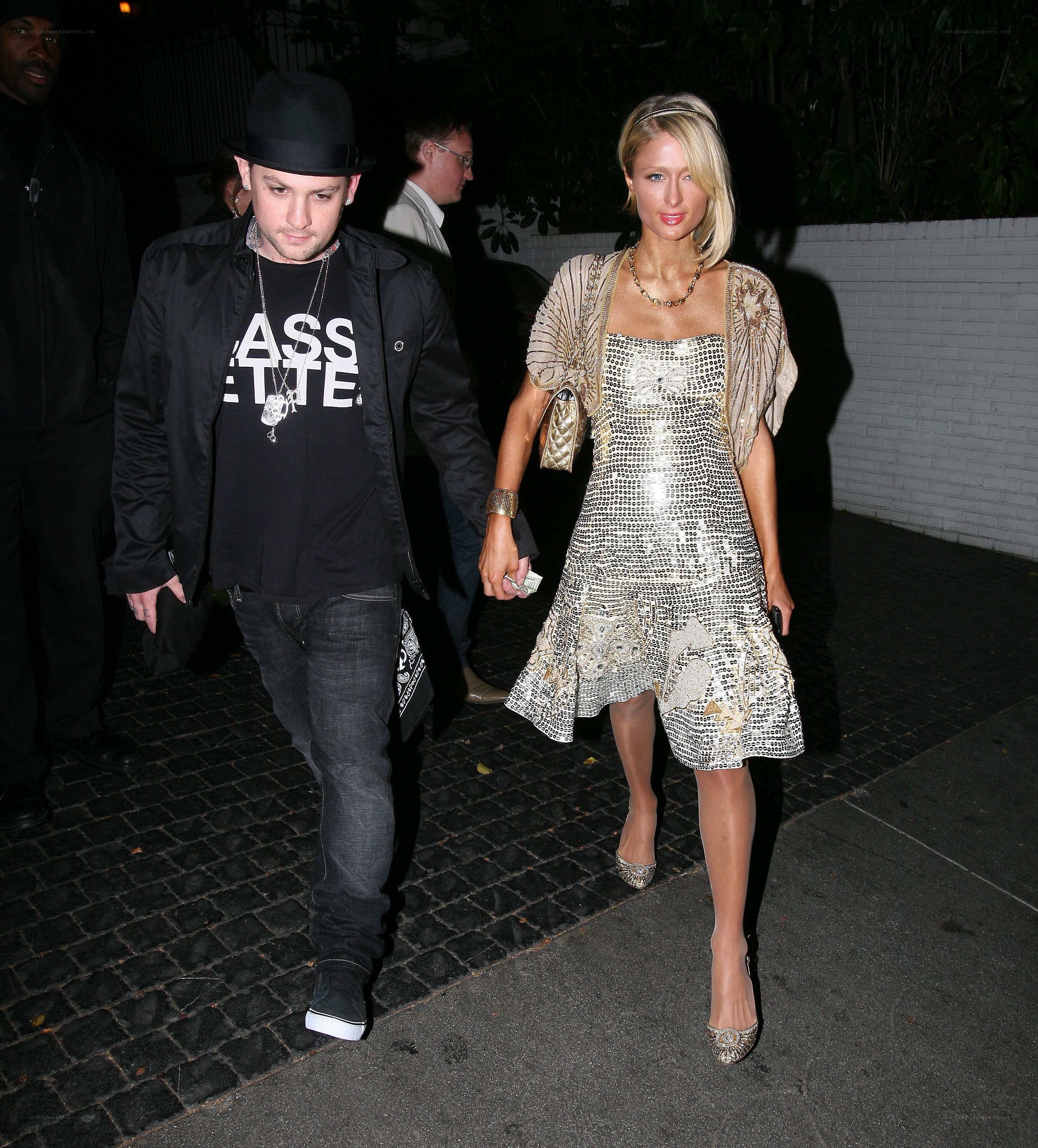 Paris Hilton and a man walking