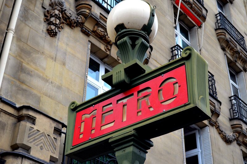 Paris Metro sign on a street lamp