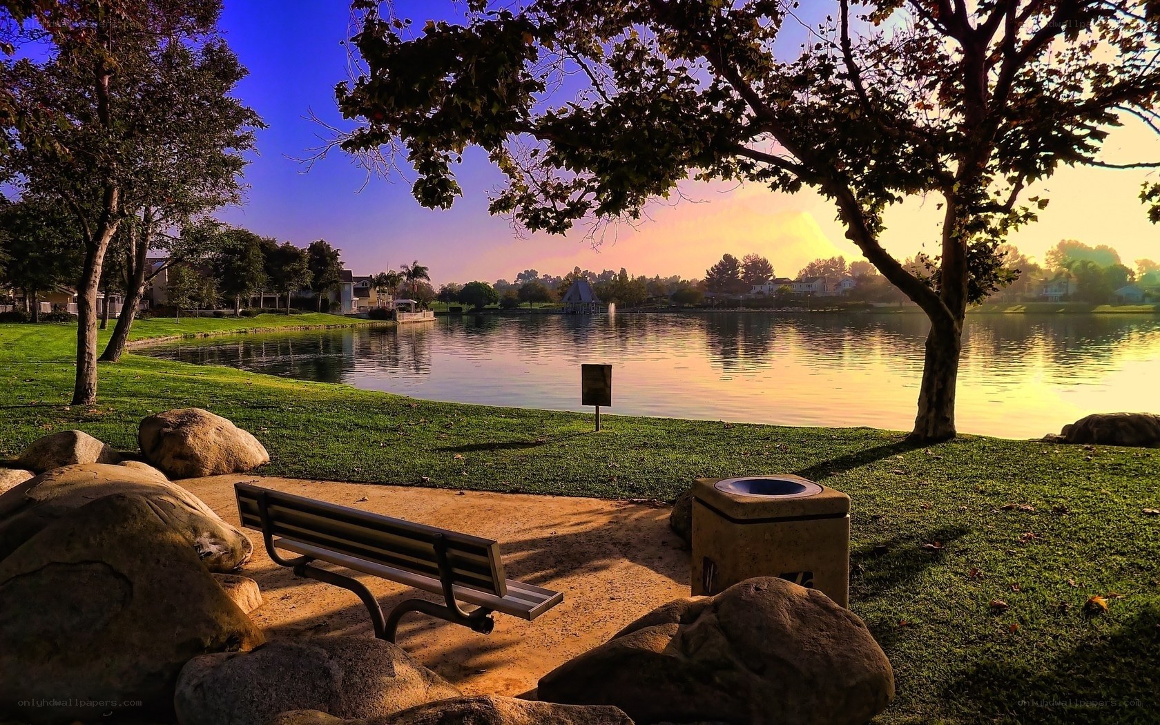 Park bench by the lake at sunset