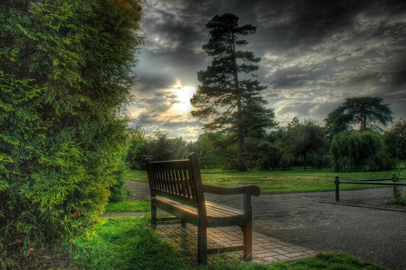Park bench under cloudy sky
