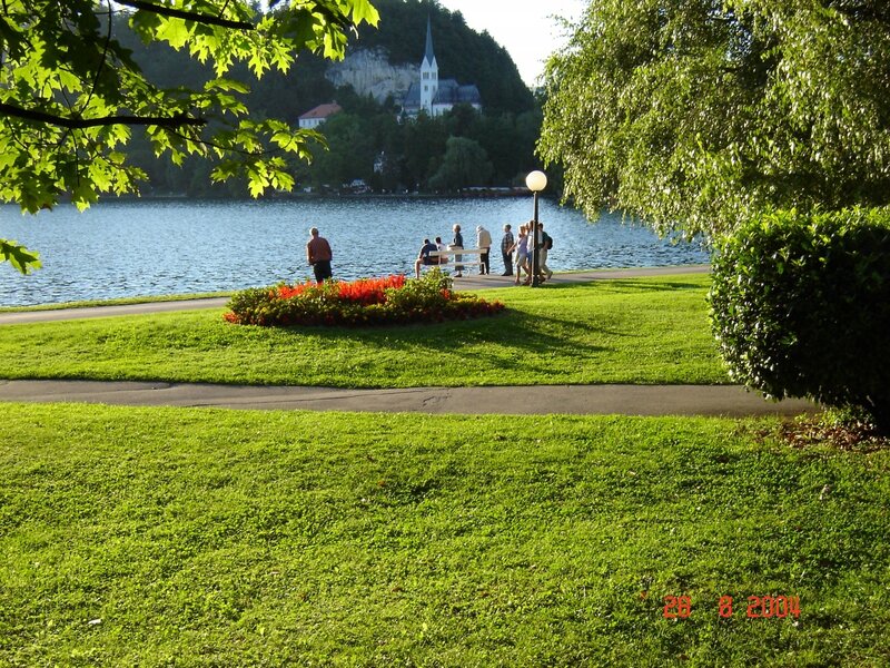Park by a lake with church