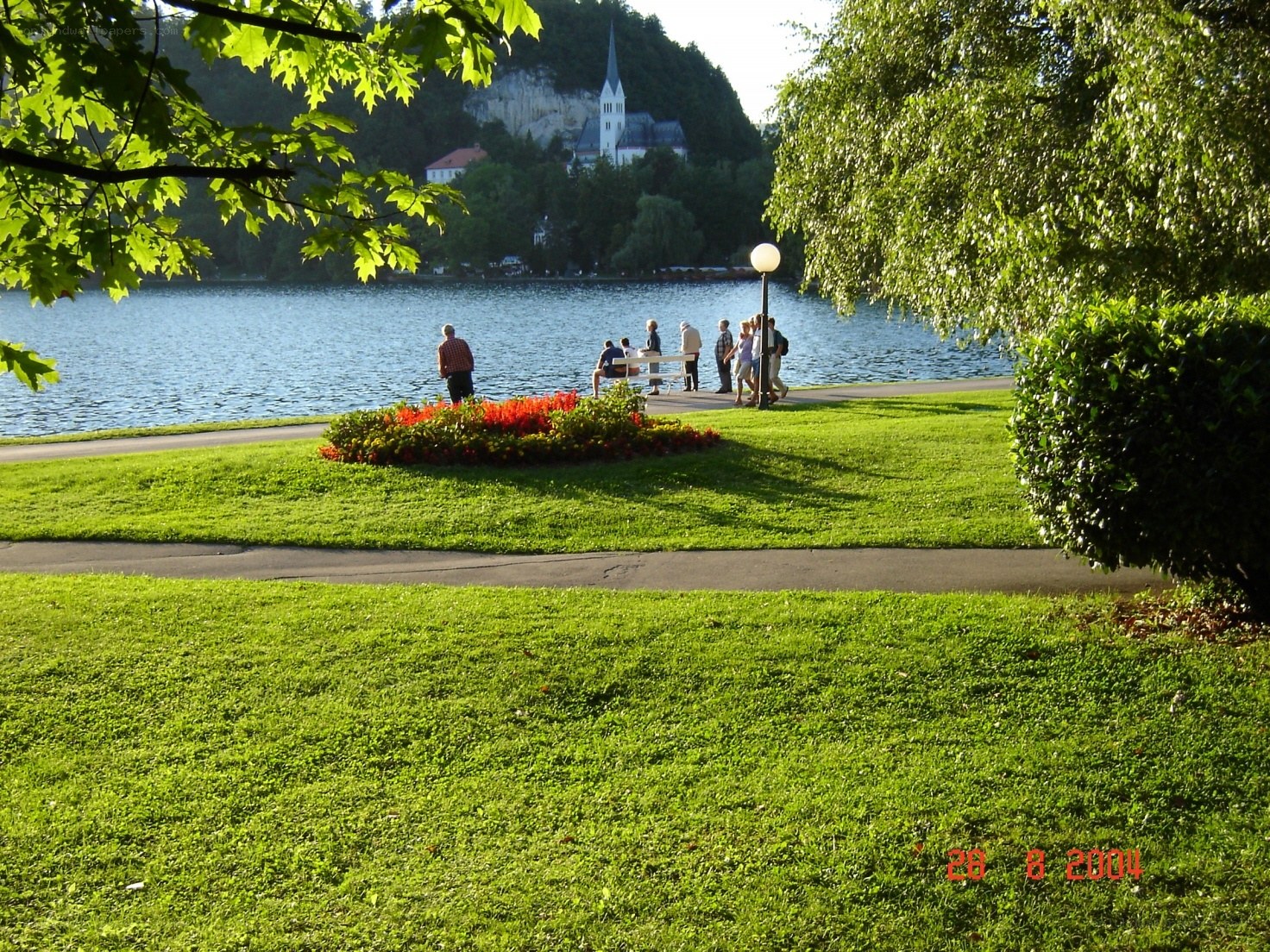 Park by a lake with church