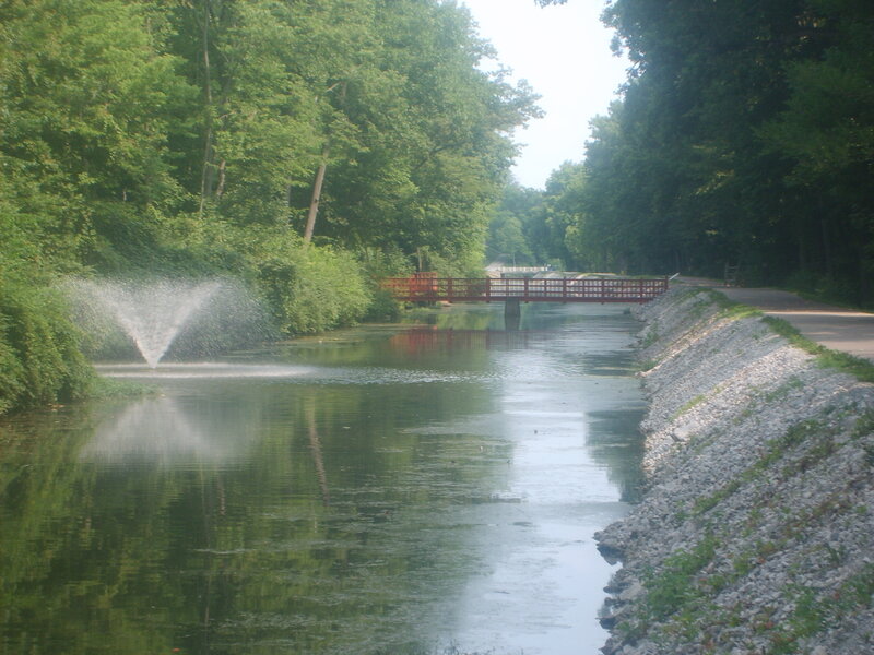 Park canal with fountain and bridge