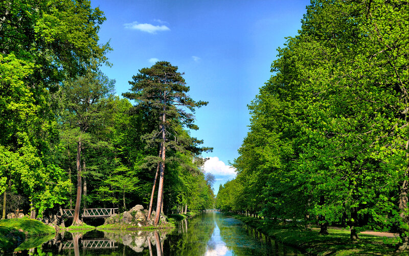 Park canal with trees and bridge