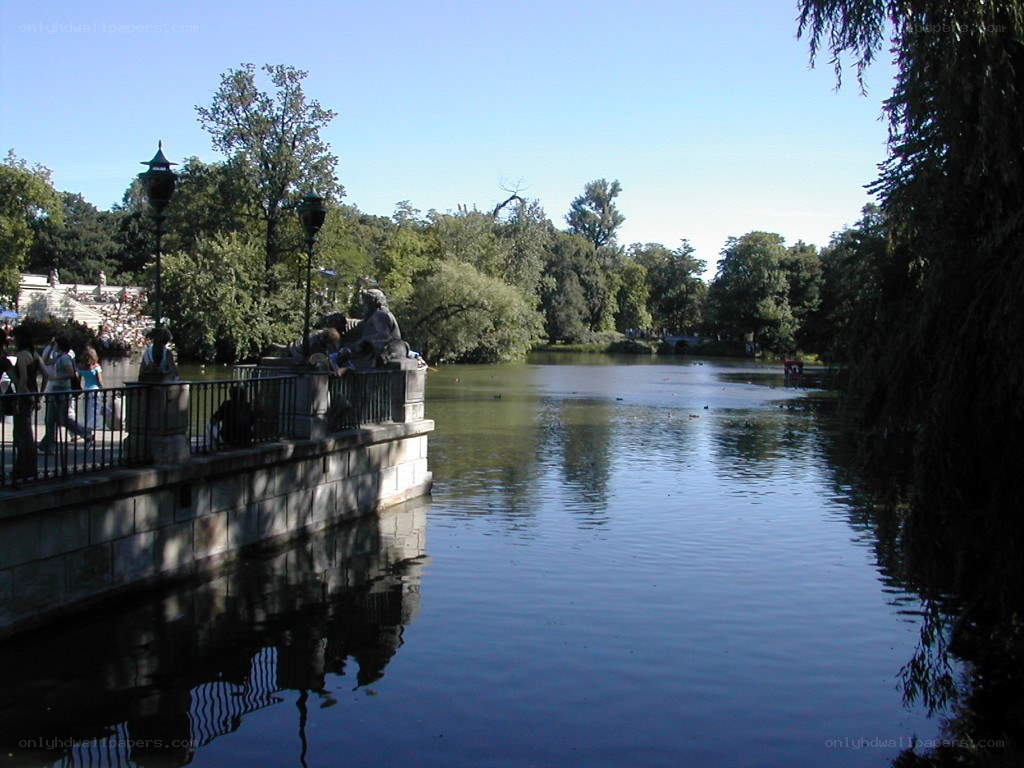 Park lake with statues and visitors