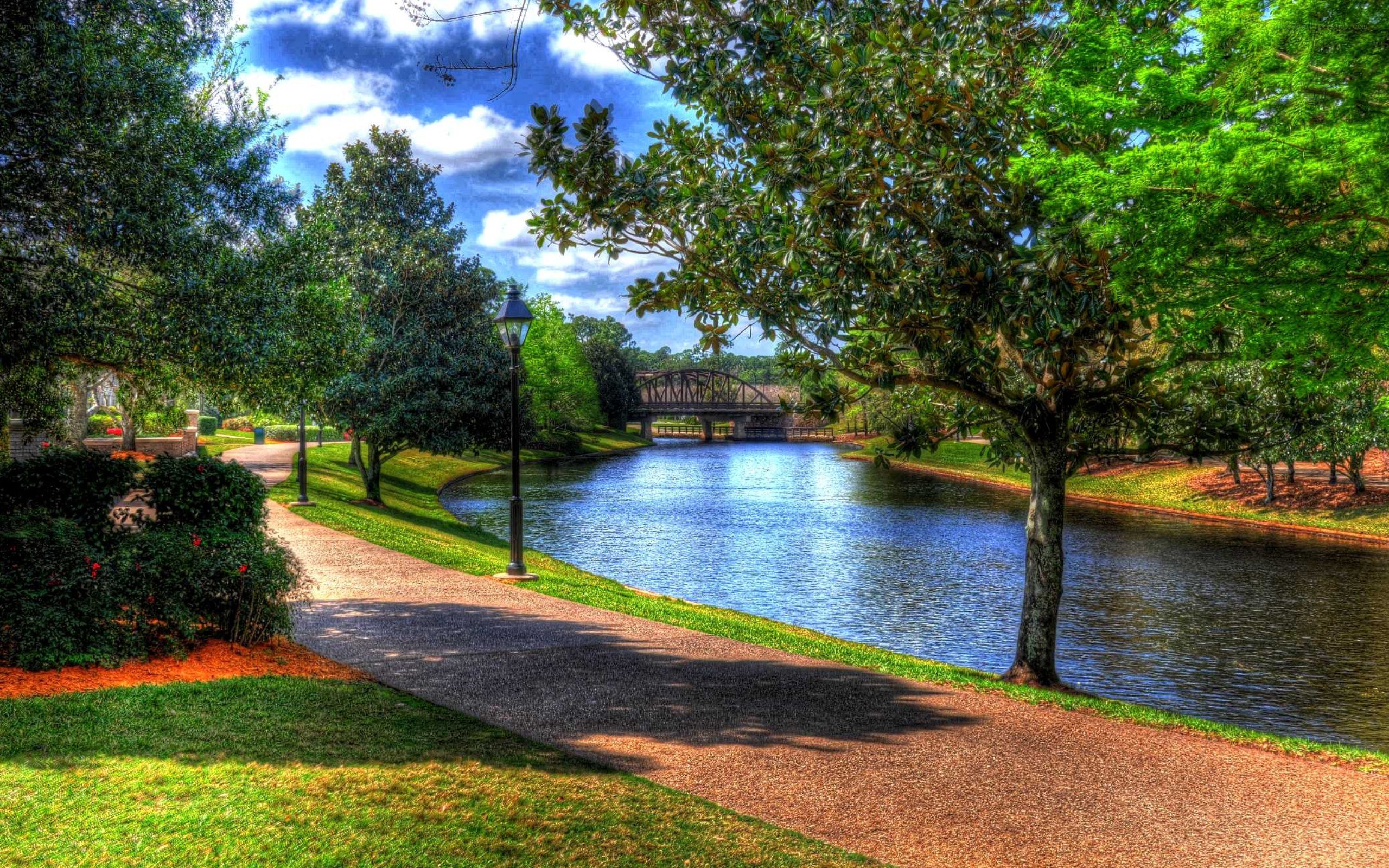 Park path by river with bridge