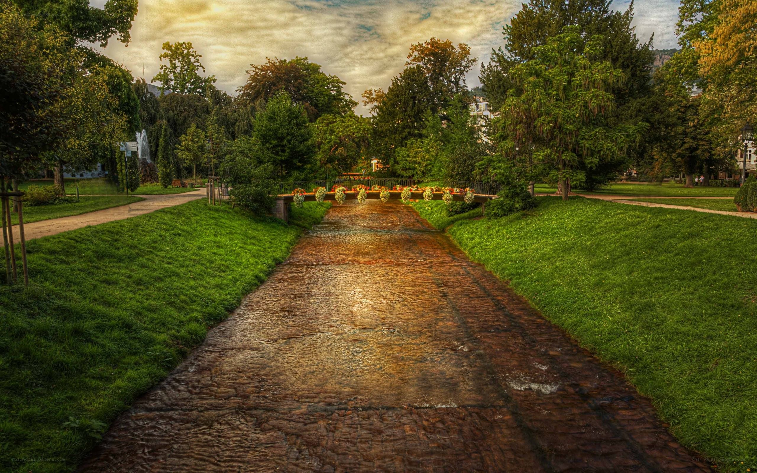 Park path with fountain and bridge