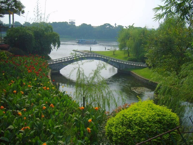 Park with arched bridge and river