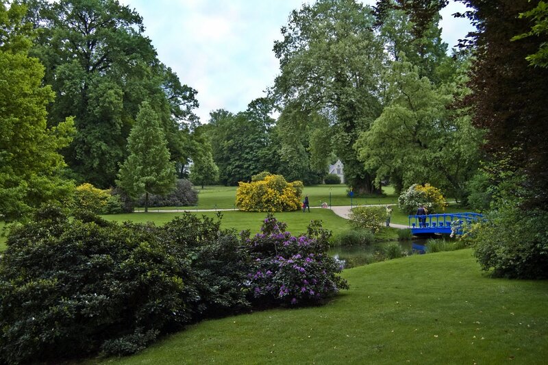 Park with blue bridge and flowers