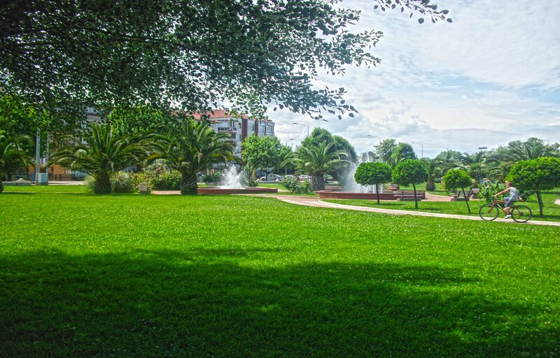Park with fountain and cyclist
