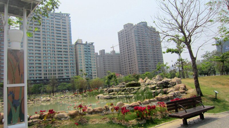 Park with Pond and Buildings