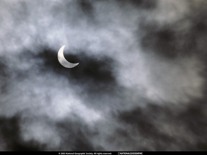 Partial solar eclipse through clouds