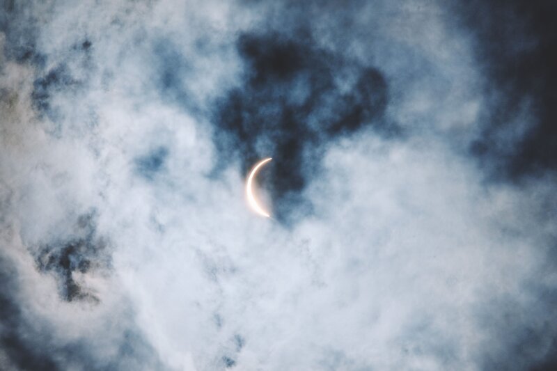 Partial solar eclipse through clouds