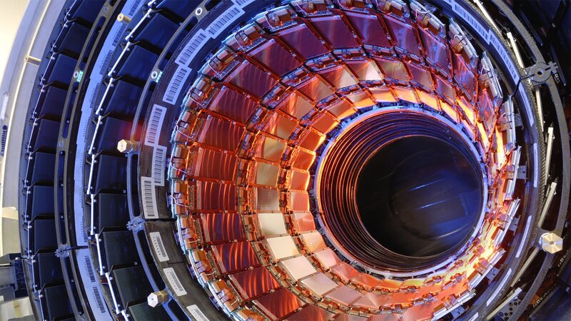 Particle Detector — Orange, Technical, Photograph, Circular Structure, Metallic Components, Barcodes