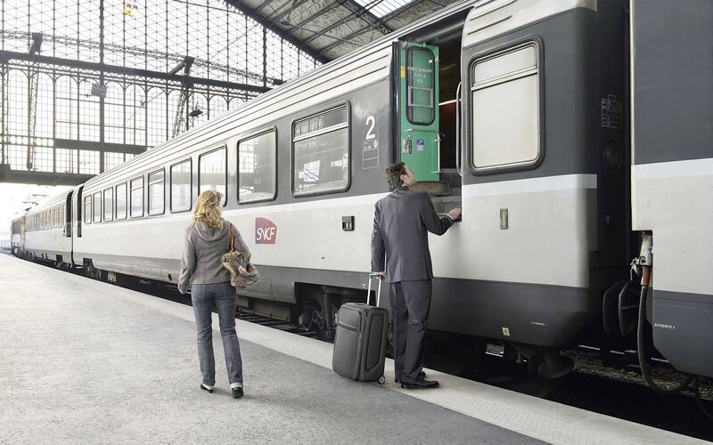 Passengers at Train Station — Gray