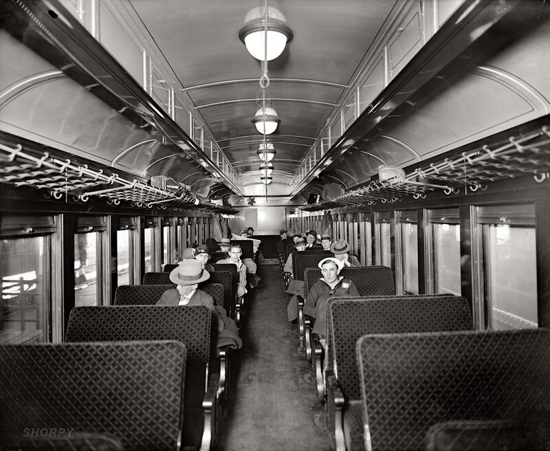 Passengers inside a vintage train car