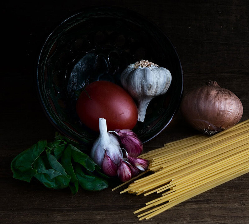 Pasta ingredients on dark table