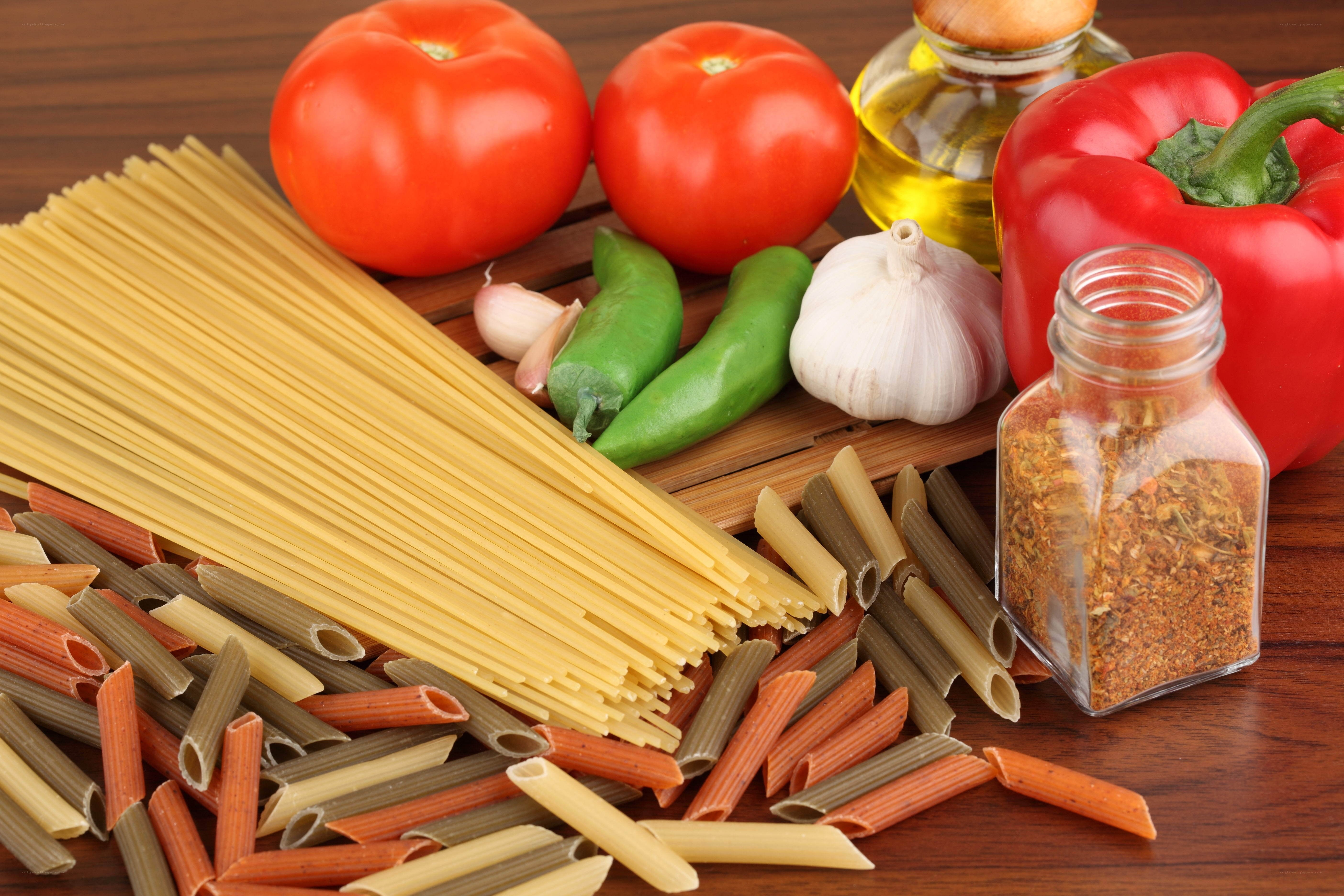 Pasta ingredients on wooden table
