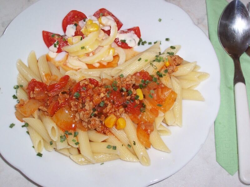 Pasta with tomato sauce and salad
