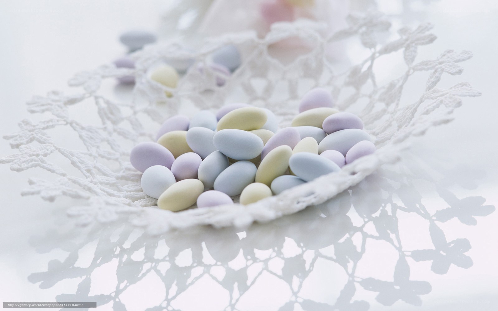 Pastel candies in lace bowl