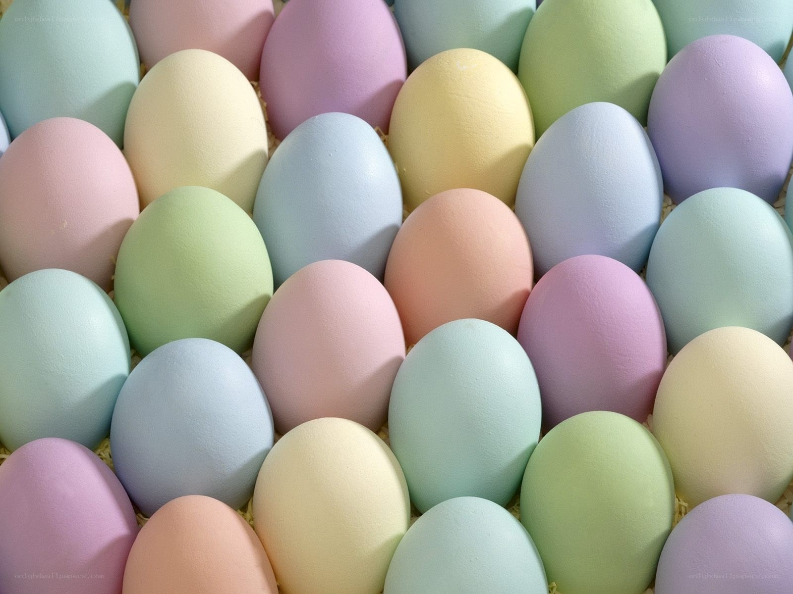 pastel-colored eggs in a basket