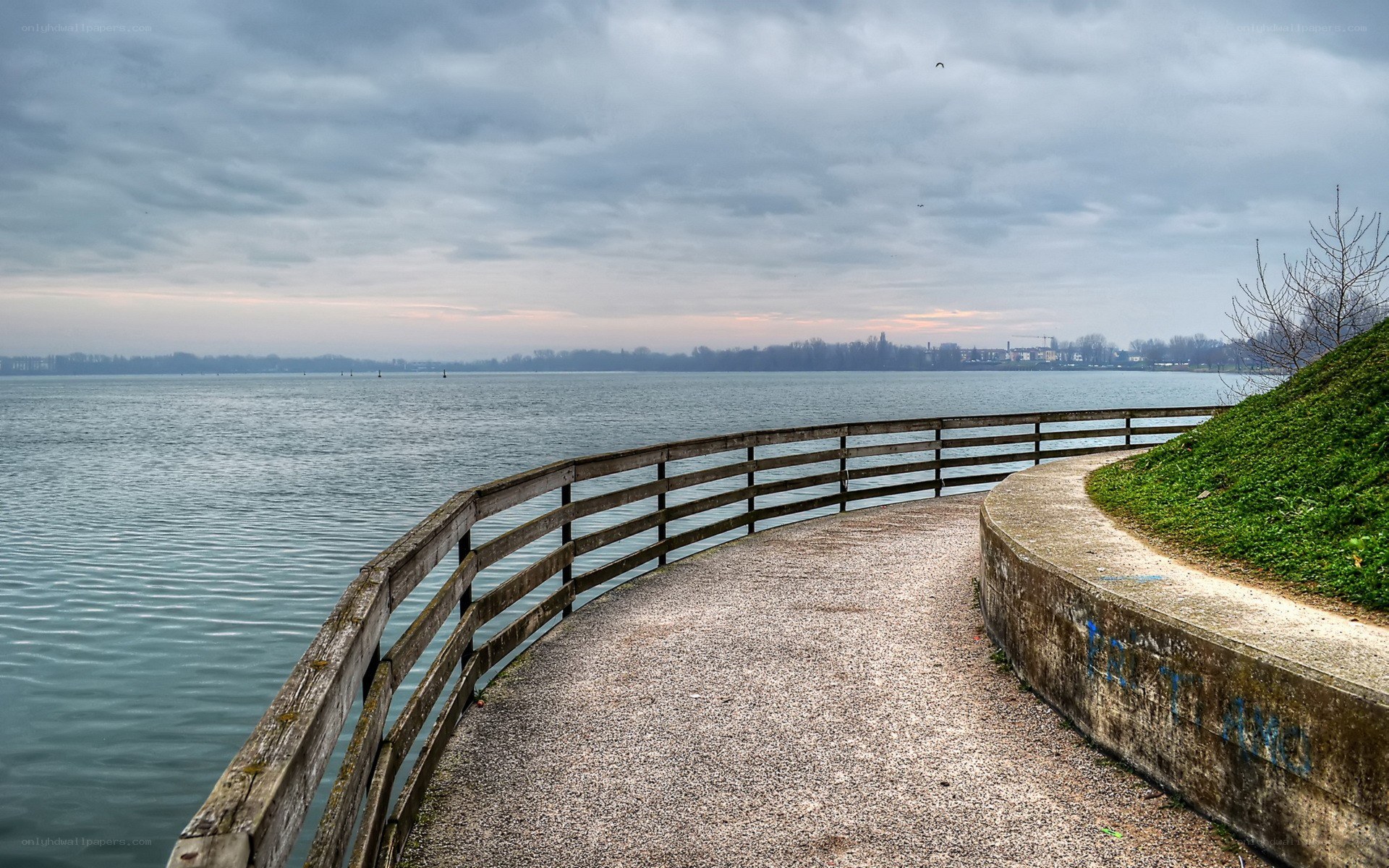 Path along a lake on an overcast day