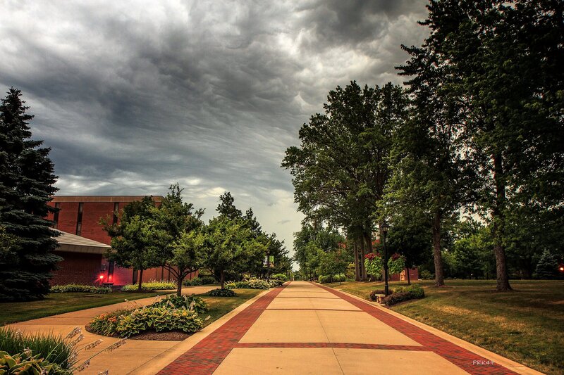 Pathway under stormy sky