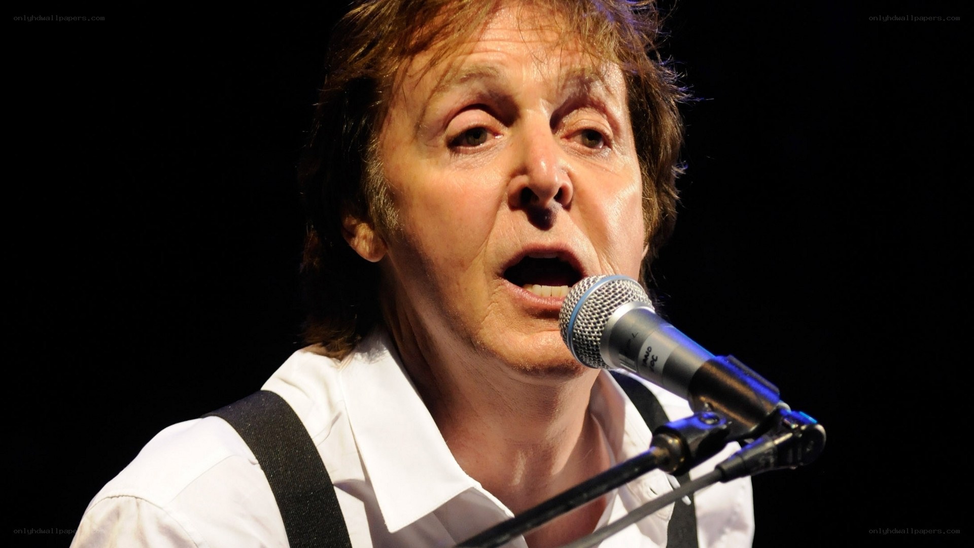 Paul McCartney singing on stage