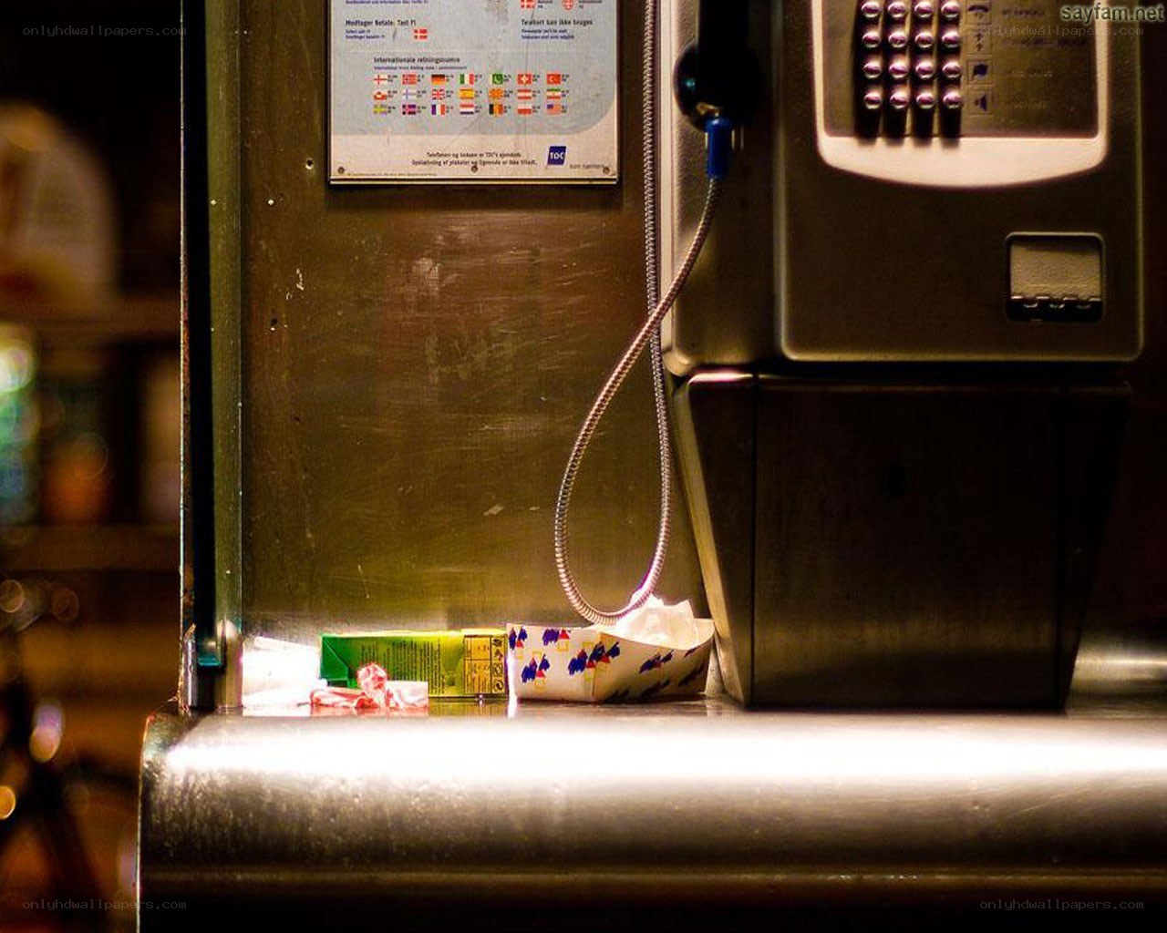 Payphone with trash on counter